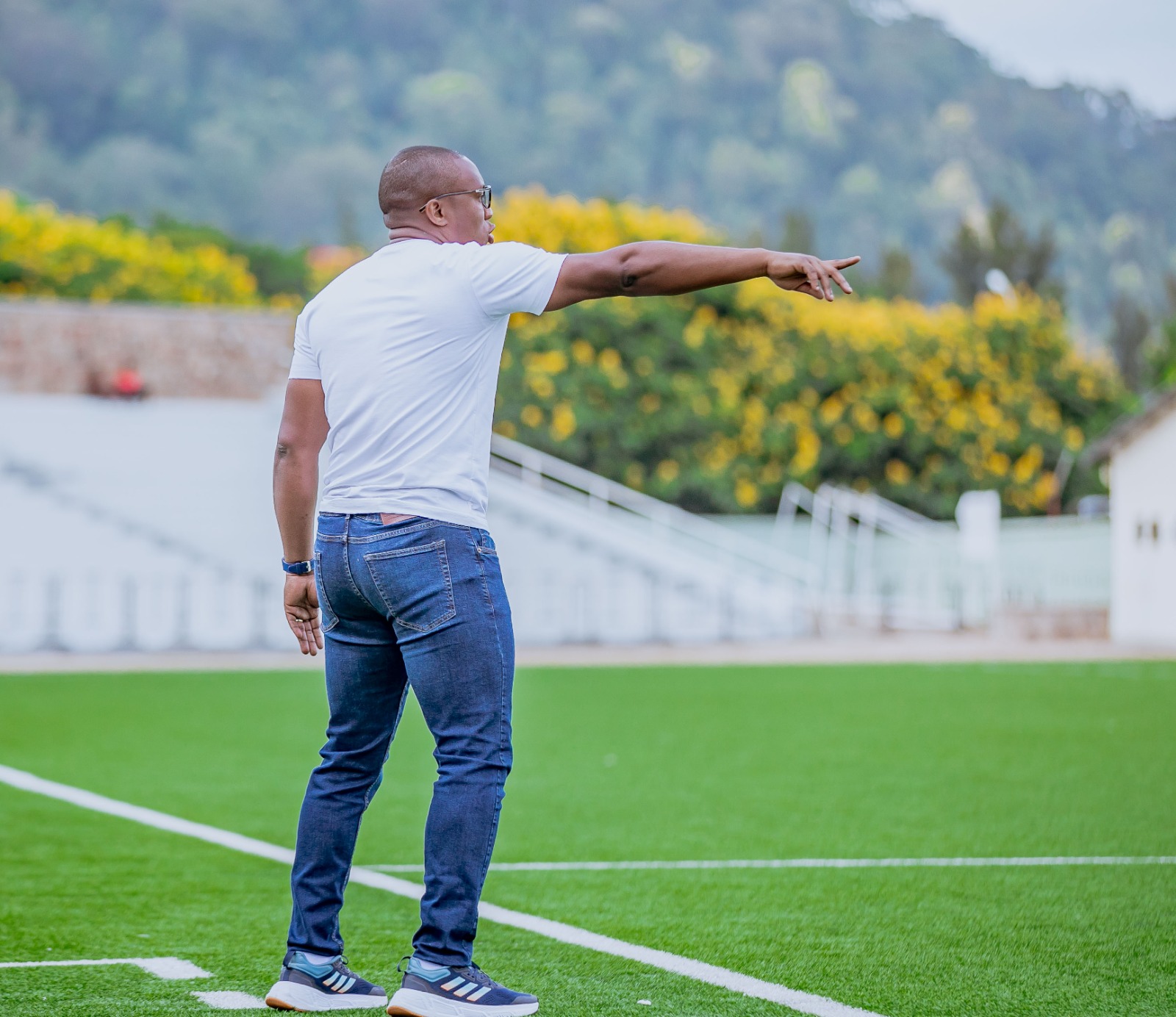 Standing pitch side doing coaching